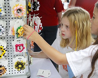 MADELYN P. HASTINGS | THE VINDICATOR..(L-R) Abigal Smolko, 7, and Emily Macik, 8, of Niles admire the 'Sweet Blossoms' bows at the Fall Festival at Stevens Park in Niles on Saturday, October 5, 2013. ... - -30-..