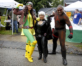 MADELYN P. HASTINGS | THE VINDICATOR..(L-R) Riley Rivera of Cleveland, Stephanie Karasevich of Cleveland, and Michael Knightmage of Youngstown, pose for a portrait dressed as X-Men's Storm, X-Men's Rouge and the Daredevil respectively at the fourth annual Lawn-Con on the west side on Saturday, October 5, 2013. ... - -30-..
