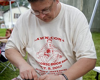 MADELYN P. HASTINGS | THE VINDICATOR..Illustrator Ron Frenz signs a comic book at the fourth annual Lawn-Con on the west side on Saturday, October 5, 2013. ... - -30-..