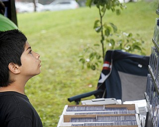 MADELYN P. HASTINGS | THE VINDICATOR..Jacob Wolf, 9, of Boardman, looks at comic book collectables at the fourth annual Lawn-Con on the west side on Saturday, October 5, 2013. ... - -30-..