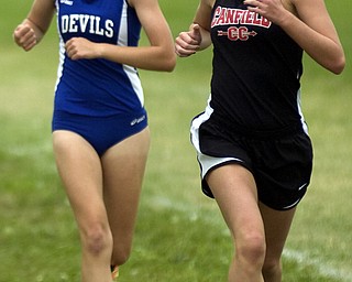 Kelli Cardinal/The Vindicator .Devin Foley, a senior from Canfield, battles Saturday to stay ahead of a runner from Brunswick in the girls Division I race during the Legends Cross Country Meet at Trumbull County Fairgrounds.