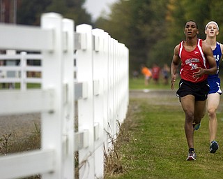 Kelli Cardinal/The Vindicator .Derrian White, a senior from Shaker Heights, keeps a steady pace Saturday ahead of Steve Wahl, a senior from Brunswick, in the boys and girls Division I open race during the Legends Cross Country Meet at Trumbull County Fairgrounds.