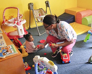 MADELYN P. HASTINGS | THE VINDICATOR..Vonetta Davis plays with 1 year old Alexia Moorer in Banana Darlings Learning Center on YoungstownÕs East Side. Davis has worked with children for more than 20 years, but this is her first business venture. .... - -30-..