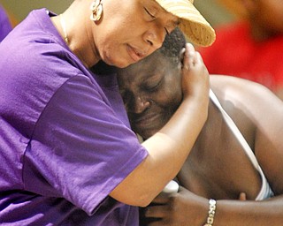 MADELYN P. HASTINGS | THE VINDICATOR..(L-R) Shirlene Hill and Caffie Williams (ok) embrace each other during a rally to kick off nonviolence week in downtown Youngstown on Sunday, October 6, 2013.... - -30-..