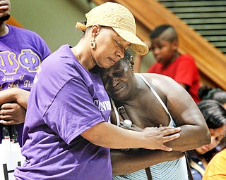 MADELYN P. HASTINGS | THE VINDICATOR..(L-R) Shirlene Hill and Caffie Williams (ok) embrace each other during a rally to kick off nonviolence week in downtown Youngstown on Sunday, October 6, 2013..... - -30-..