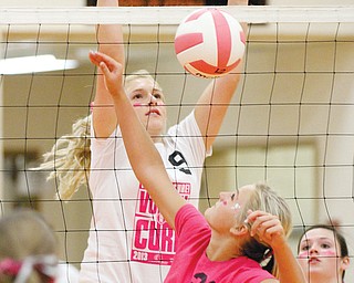 Springfield’s Marissa Buchenic (21) and East Palestine’s Carley Sansenbaugher (9) battle at the net during a volleyball match Tuesday night at Springfield. The host Tigers beat the Bulldogs, 25-21, 25-8, 25-17.