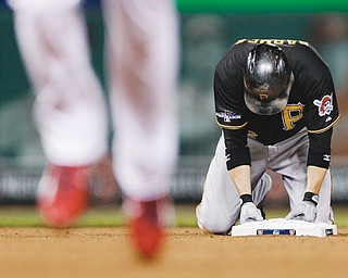 The Pirates’ Clint Barmes kneels on second base after being forced out on a double play to end the sixth inning of Game 5 of the National League Division Series against the St. Louis Cardinals on Wednesday at Busch
Stadium in St. Louis. The Pirates’ storybook season came to an end in a 6-1 loss to the Cardinals. St. Louis will
face the LA Dodgers in the championship series, which begins Friday in St. Louis.