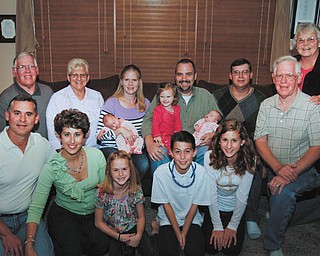 Members of the Schrock family include, front from left, Michael and Michelle Schrock with their three children, Allison and Adam, both 9, and Madison, 12; and David Schrock. In back are, from left, Don and Debbie Schrock; Dawn and Rick Laslow holding their three children, Alyssa and Alonna, 10 weeks, and Danielle, 2; and Jackie Schrock.
Photo by MADELYN P. HASTINGS I THE VINDICATOR
