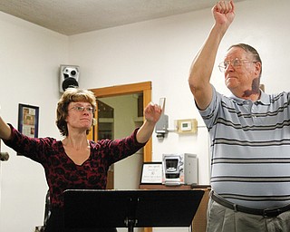 Jim Antell, choir director at Girard First United Methodist Church, and his daughter, April Antell Tarantine, who directs the choir in her father’s absence, take the choir through a recent rehearsal. Antell has served 50 years as choir director at the church.