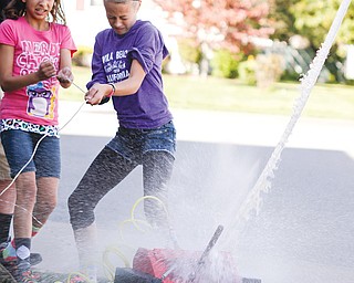 Girard Intermediate School fifth-graders Brooke Kennedy, left, and Kayley McConnell shoot off a bottle rocket
Thursday during a regular meeting of the Bottle Rocket Club.
