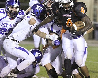 William d. Lewis The Vindicator Howland's Jaquore Marrs(4) eludes a host of Poland defenders for 1 rst qtr yardage during 10-11-13 game at Howland.