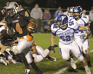 William d. Lewis The Vindicator Howland's (4) eludes Poland defenders Mike Audi(52) and Austin Wilson(24) for 1 rst qtr yardage during 10-11-13 game at Howland.
