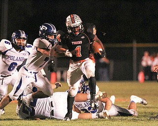 William d. Lewis The Vindicator Howland's Jaquore Marrs (4) Poland defenders Geno Petrus(6) and Jason Morucci(7) during 10-11-13 game at Howland.