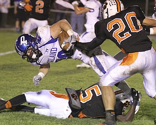 William d. Lewis The Vindicator Poland's Ross Gould(20) is stopped by Howland's Ameer Williamson(5) and ( Keith Crocker(20) during 10-11-13 game at Howland.