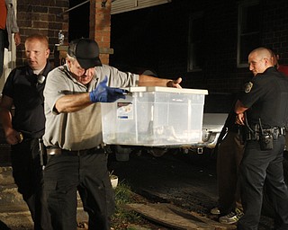 ROBERT K. YOSAY | THE VINDICATOR..over 150 snakes some venomous were discovered at a house - 438 Fifth st in struthers this afternoon.. Mahoning County Dog Warden and Det. Jeff Lewis Stuthers PD.. moved the animals to a car that will be taken to Kentucky ( poisonus ones) and Cleveland ( non Venoumous ) - The owner was charged with several charges .. - -30-..