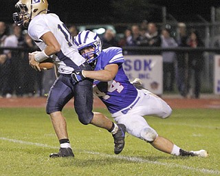 . ROBERT K. YOSAY | THE VINDICATOR..Lowellville #16 Alex Harklerode is brought down for a loss by WR #44Dan Zilke during third quarter action Lowellville at Western Reserver