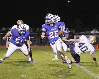 . ROBERT K. YOSAY | THE VINDICATOR..WR #25 Brian Sunderman leaves #40 lowellville Evan Amos as #51 WR R J Jones watch as he goes for a first down.Lowellville at Western Reserver