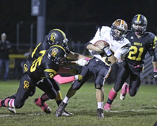 Springfield's Graham Mincher (10) of Springfield scrambles out of the pocket after being met by numerous Crestview defenders during the first quarter of Friday nights matchup at Crestview High School. Dustin Livesay | The Vindicator 10/11/13 Crestview High School.