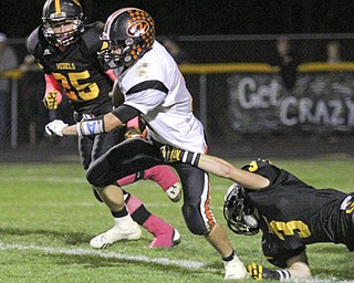 Ryan Kohler (11) of Springfield breaks through a shoe string tackle by Spencer DeSalvo (3) of Crestview during the second quarter of Friday nights matchup at Crestview High School. Dustin Livesay | The Vindicator 10/11/13 Crestview High School.