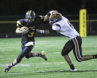 Quarterback Colin Gilbert (9) of Crestview stiff arms Mike Allgower (6) of Springfield during the second quarter of Friday nights matchup at Crestview High School. Dustin Livesay | The Vindicator 10/11/13 Crestview High School.