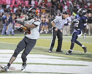 Massillon running back #29 Lyron Wilson celebrates after crossing the goal line after beating Fitch defensive back #2 Brian Pressley in the first quarter.