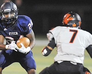 Fitch #24 Darrin Hall attempts to put a move on Massillon defensive back #7 Reggie Rogers after breaking ingot he open field on a running play.
