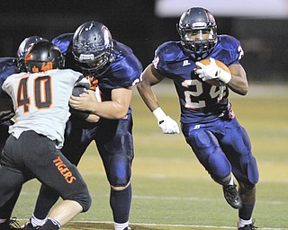 Fitch #24 Darrin Hall follows the block of teammate #69 Chuck Zaborsky on Massillon #40 Jacob Zentkovich after getting the corner on a running play.