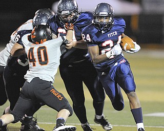 Fitch #24 Darrin Hall follows the block of teammate #69 Chuck Zaborsky on Massillon #40 Jacob Zentkovich after getting the corner on a running play. Fitch #36 C.J. Martini pictured.