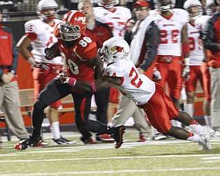 ROBERT K. YOSAY | THE VINDICATOR..YSU #80 Andrew Williams aafter catching a 20 yard pass is brought down by #24 Mike Banks and a first down..YSU vs Illinois State.. - -30-..