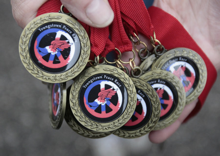  .          ROBERT  K. YOSAY | THE VINDICATOR..The new peace race medal that every runner received, that ran the 400m race .The 39th Annual Peace Race -  with over 2000 runners on a beautiful October day