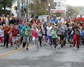 . ROBERT K. YOSAY | THE VINDICATOR..And they are off as the 400 m race downtown as the 10 and under runners leave central square running west on West Federal.....The 39th Annual Peace Race - with over 2000 runners on a beautiful October day
