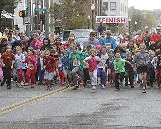 . ROBERT K. YOSAY | THE VINDICATOR..And they are off as the 400 m race downtown as the 10 and under runners leave central square running west on West Federal.....The 39th Annual Peace Race - with over 2000 runners on a beautiful October day