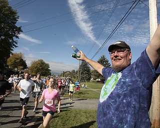 . ROBERT K. YOSAY | THE VINDICATOR..helping out the runners with beverages is Rick Dunn of Kirk rd..The 39th Annual Peace Race - with over 2000 runners on a beautiful October day