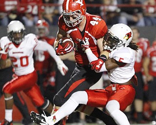 ROBERT K. YOSAY | THE VINDICATOR..YSU #44 Nate Adams is corraled by Illinois State #5 Tevin Allen after a 27 yard pass and a first down - behind him is illinois #20 Dominic Clark..YSU vs Illinois State.. - -30-..
