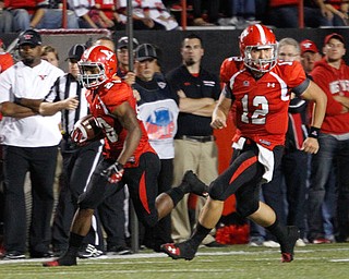 ROBERT K. YOSAY | THE VINDICATOR..Number 29 YSU Martin Ruiz after taking the latteral from #12 Kurt Hess - scampered for 7 yards and first down..YSU vs Illinois State.. - -30-..