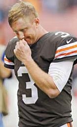 Browns quarterback Brandon Weeden walks off the field after Sunday’s loss to Lions in Cleveland. His backhanded flip to Chris Ogbonnaya was intercepted with 4:36 left, and Detroit rallied to win 31-17.