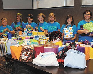 SPECIAL TO THE VINDICATOR
Noah McLemore, an eighth-grader from Canfield whose aunt was diagnosed with pancreatic cancer, looked for ideas to help her feel better. He and his mother put together a package he calls a “cancer care bag.” For three months he and other middle school students collected donations of items and prepared the bags. The bags each contain a water bottle, lip balm, mints, a lap blanket and a journal. They delivered 108 bags to the Joanie Abdu Comprehensive Breast Care Center, and two bags were given to people the children know, who are suffering with cancer. Above, middle school students participating, from left, are Noah Clark and Emily Hura of Columbiana; Elijah McLemore of Canfield, Savannah Pew of Greenford, Natasha Flak of Salem, Cheyenne Trump of New Waterford and Noah McLemore.