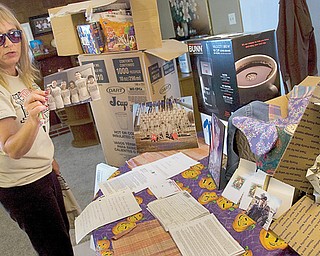 Sandra Emmons of Youngstown shows a photo with members of her family wearing a T-shirt made to get the word out about Support Our Soldiers, a care-package program she started in May after her son was deployed to Afghanistan. Since then, she has sent more than 20 packages to her son, Army Pvt. Michael Bayless, and other military personnel.