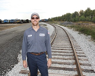 Matt McComber, operations manager at the Ohio Commerce Center in Lordstown for the company Savage, stands
on some of the new train tracks that have been installed at the center.
