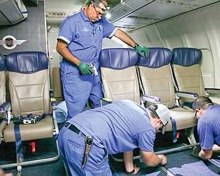 Southwest Airlines aircraft technicians install newer, skinnier seats on a 737 at the carrier’s headquarters
in Dallas. Southwest says passengers will have the same amount of legroom even though the new seats allow for another row on board.