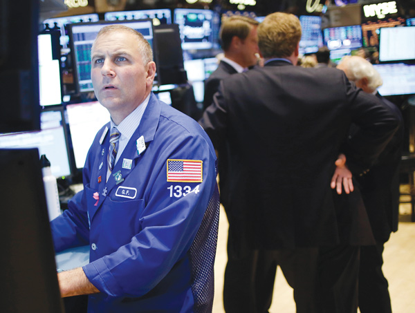 Traders work on the floor at the New York Stock Exchange in New York on Wednesday. Stocks surged on Wall Street after Senate leaders reached a deal that would avoid a U.S. default and reopen the government after 16 days of being partially shut down.