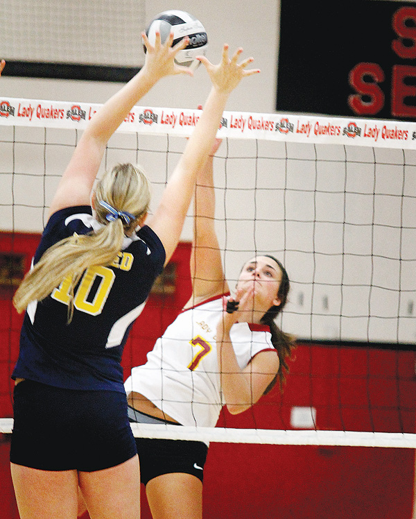 At left, United’s Taylor John (10) tries to keep Cardinal Mooney’s Jaclyn Yankle (7) from spiking the ball during
a Division III sectional match Wednesday at Salem High School. The Cardinals downed the Golden Eagles, 3-0,
to advance to Monday’s next round against the Crestview Rebels, who swept Liberty in three games Wednesday in
Salem. 