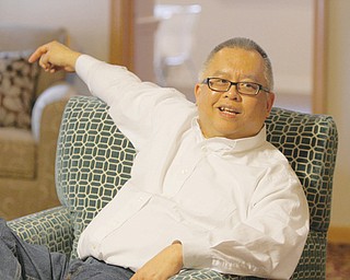 David Ho, owner of the American Scholar Group, an organization that brings in international students to study in the United States, relaxes in the hall’s living area.