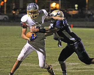 McDonald's Jake Reckard (9) attempts to shed the tackle by Lowellville's Robert Ciccone (24) during the first quarter of Friday nights matchup at Lowellville High School.  Dustin Livesay  |  The Vindicator  10/18/13  Lowellville High School.