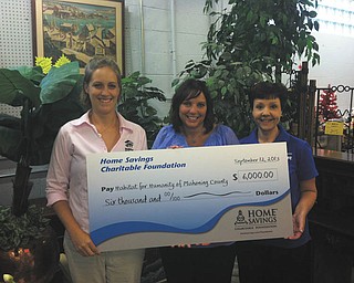 Monica Craven, left, executive director of Habitat for Humanity of Mahoning County; Chris Appugliese, center, retail manager of Home Savings Struthers office; and Linda Hartwig, ReStore manager of Habitat for Humanity, hold a $6,000 check recently donated to Habitat for Humanity by the Home Savings Foundation. The donation will be used to replace the roof on the ReStore in Struthers. For information about Habitat for Humanity of Mahoning County and its services, call 330-743-7244 or visit www.habitatmahoningcounty.org. 
SPECIAL TO THE VINDICATOR