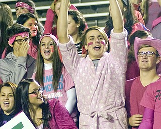 Kelli Cardinal/The Vindicator .Gabriel Bleacher, center, a senior at Ursulin, cheers with fellow senior Gabrielle Villaplana, left, during the second quarter Friday night at Stambaugh Stadium in Youngstown.