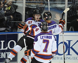 Phantoms #27 Luke Stork celebrates after scoring a goal with teammates #44 Kiefer Sherwood and #7Maxim Letunov during 3rd period action of a game on Friday October 18, 2013.