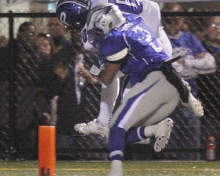  .          ROBERT  K. YOSAY | THE VINDICATOR.. Hubbards #2 Aries Shaw does his best to push Polands #20 Ross Gould out of bounds as Gould picks his way into the end zone..Poland Bulldogs @ Hubbard Eagles