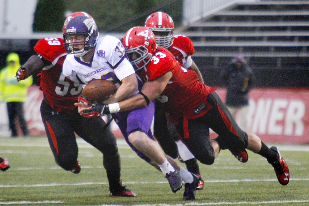 MADELYN P. HASTINGS | THE VINDICATOR..YSU's Terrell Williams (59) and Kyle Sirl (33) tackle Western Illinois' Nathan Knuffman (33) during Youngstown's homecoming game on October 19, 2013.... - -30-..