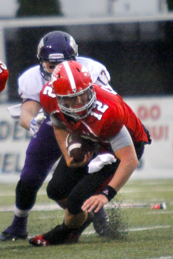MADELYN P. HASTINGS | THE VINDICATOR..YSU's Kurt Hess (12) runs with the ball from Western Illinois' Kevin Kintzel (17) during Youngstown's homecoming game on October 19, 2013.... - -30-..